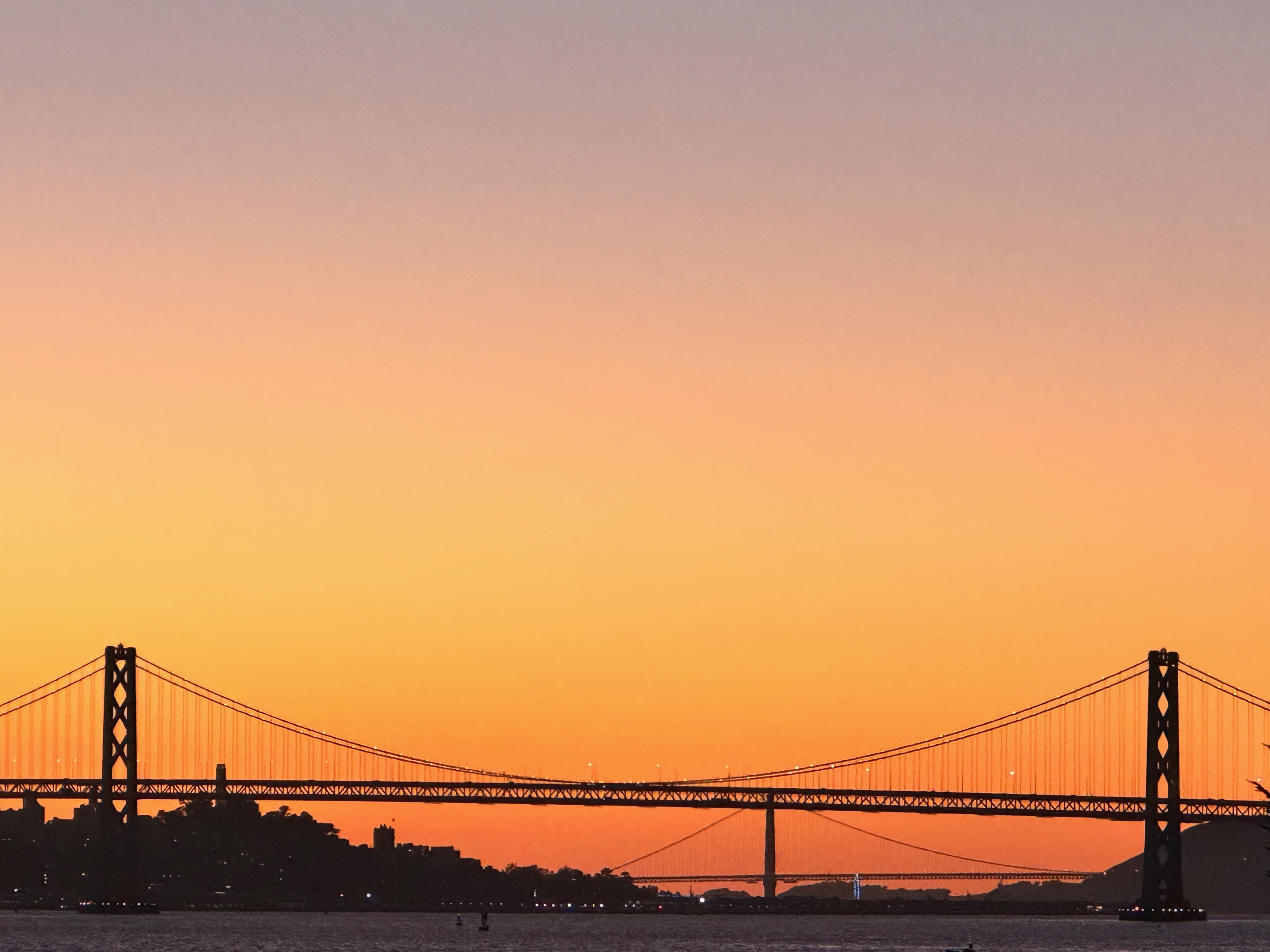 the Bay Bridge and the Golden Gate Bridge at sunset